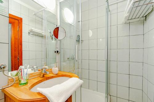 a bathroom with a sink and a shower at Hotel Dalmacija in Vela Luka