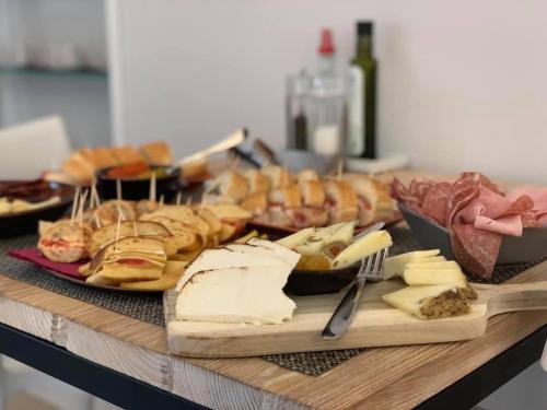a table with different types of cheese and other foods at Euterpe LHT in Agrigento