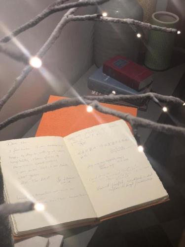 an open book sitting on top of a table with lights at Euterpe LHT in Agrigento