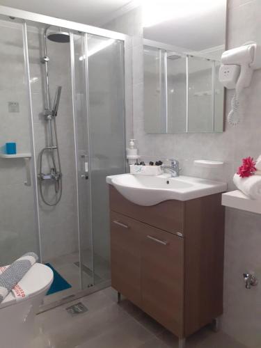 a bathroom with a shower and a sink and a toilet at Nini's House 2 Nydri - 100m from beach NYDRI TOWN CENTER in Nydri