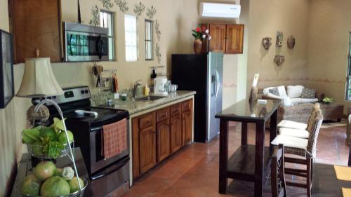 a kitchen with a refrigerator and a table in it at 3 Architectural Homes, Wi-fi and Pool in Lagunillas