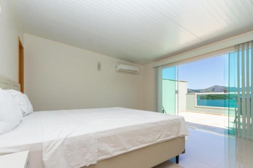 Säng eller sängar i ett rum på Conforto com vista para o mar!