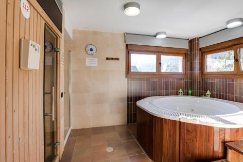 a bathroom with a tub and a window at Hotel Rural Campaniola in Pontevedra