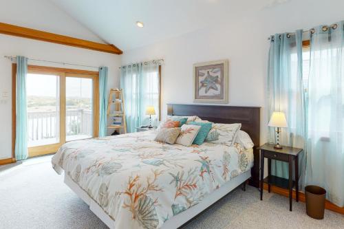 a bedroom with a bed and a large window at Frisco Sunrise 70 in Frisco