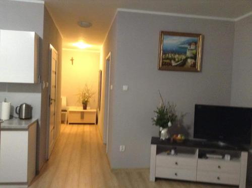 a hallway of a living room with a television at Villa Klif 10 in Trzęsacz
