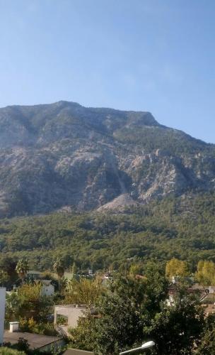 a view of a mountain with trees and houses at HELENE OTEL in Beldibi