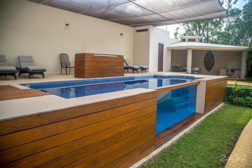 a swimming pool with a wooden fence around it at Azcapri Villa Boutique & Spa in Cancún
