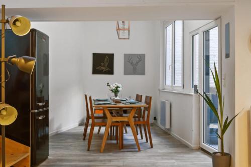 a dining room with a table and chairs at Large and calm flat in the heart of Lille - Welkeys in Lille