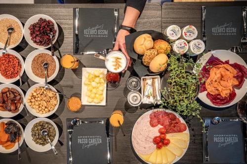 a table with a bunch of food on it at Sport Hotel Passo Carezza in Vigo di Fassa