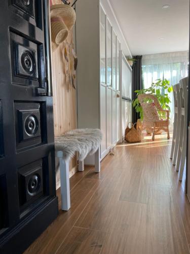 a living room with wooden floors and a black door at Julia’s Garden in Cuarte de Huerva