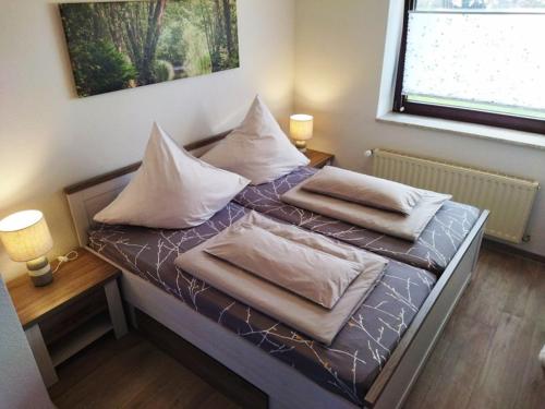 a bedroom with two beds with pillows on them at Ferienwohnung Familie Pohle in Lübbenau