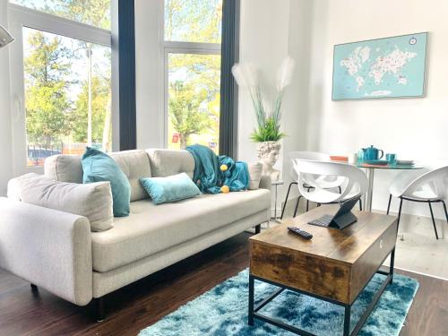 a living room with a couch and a table at Kunda House Moseley Apartments in Birmingham