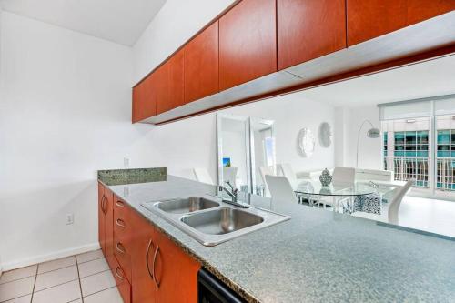 a kitchen with a sink and a dining room at Amazing Penthouse In beautiful Brickell 42 floor!! Free Garage Parking in Miami