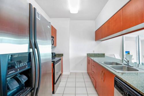 a kitchen with a stainless steel refrigerator and a sink at Amazing Penthouse In beautiful Brickell 42 floor!! Free Garage Parking in Miami