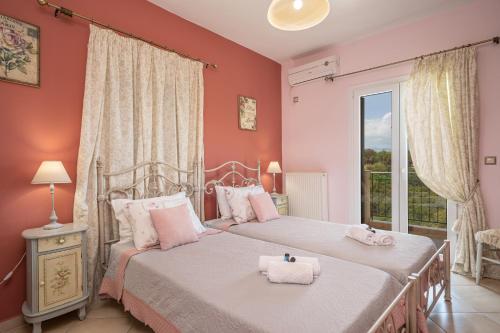 two beds in a bedroom with red walls and a window at stunning tranquil villa with private pool in Sami