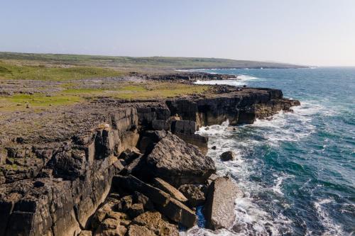 an aerial view of the cliffs of the ocean at Into The Burren in Murroogh