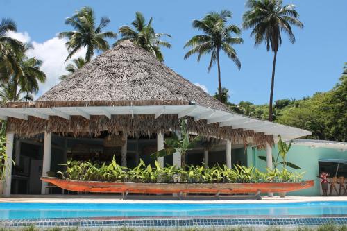 a resort with a swimming pool and a thatch roof at Mango Bay Resort in Namatakula