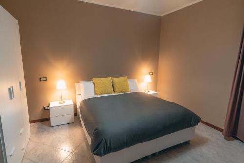 a bedroom with a large bed with two night stands at Gerosa Guest House in Lamezia Terme