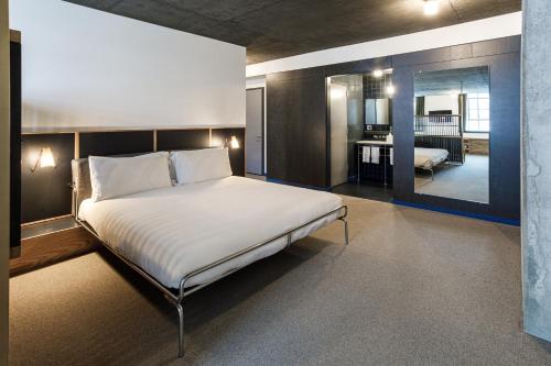 a bedroom with a large bed and a living room at The Emily Hotel in Chicago