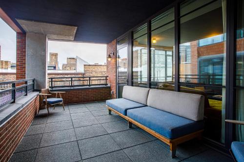 a couch on the balcony of a building at The Emily Hotel in Chicago