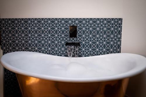 a bath tub with water coming out of it at Craig's Suites Windermere in Windermere