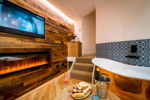 a living room with a fireplace and a tv at Craig's Suites Windermere in Windermere