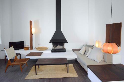 a living room with a couch and a fireplace at Cozy Townhouse in the heart of Cadaqués by by JA Coderch in Cadaqués
