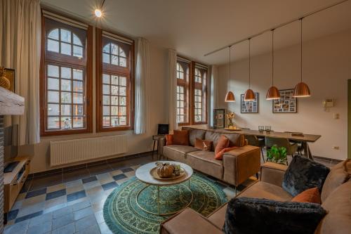 a living room with a couch and a table at LOFT d'O in Ypres