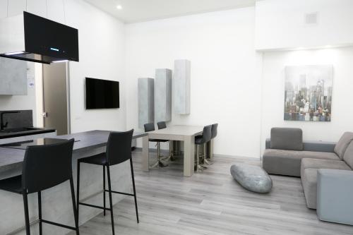 A television and/or entertainment centre at LA CORTE LUXURY APARTMENT