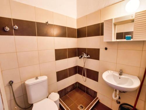 a bathroom with a toilet and a sink at Prassas Sea View in Nea Potidaea