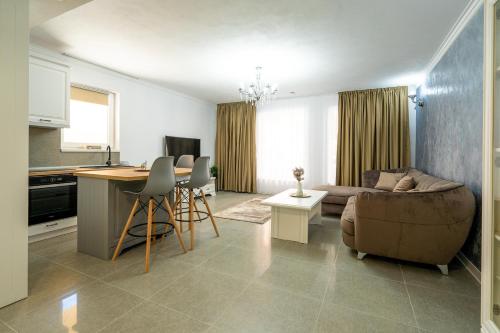 a kitchen and a living room with a couch and a table at Armada Aparthotel in Alba Iulia