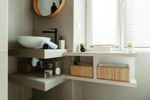 a bathroom with a sink and a mirror at La DOLCE Villetta - appartement de Standing in Mulhouse