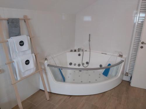 een badkamer met een wit bad en een douche bij Villa Sorella Baranja in Karanac
