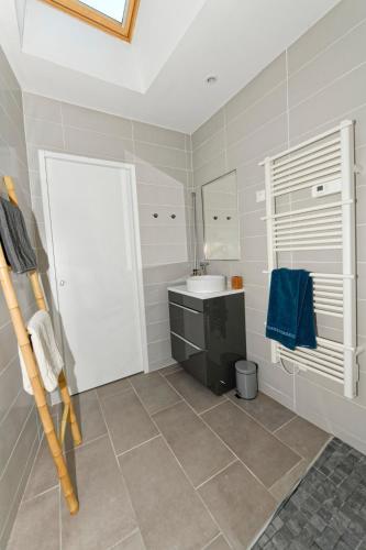a bathroom with a sink and a toilet and a mirror at A l'Abordage in Fécamp