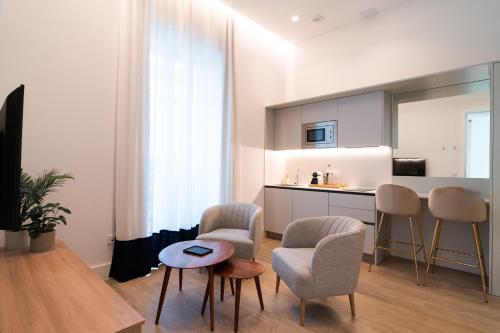 a kitchen with chairs and a table in a room at CISNES PALACE in Sanlúcar de Barrameda
