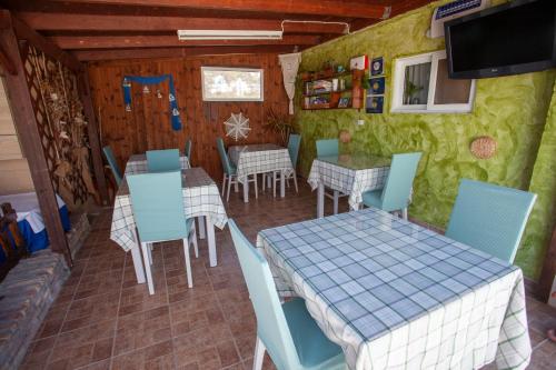 a restaurant with tables and chairs in a room at Villa Bel Passo Apartments in Kefalos
