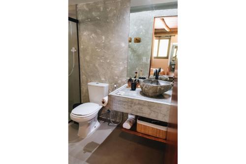 a bathroom with a sink and a toilet at Vila do Porto, Praia do Patacho - Bangalô Patacho in Pôrto de Pedras