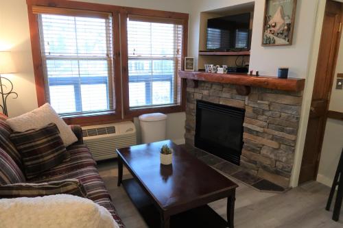 a living room with a couch and a fireplace at *APRES SKI STUDIO IN THE HEART OF THE VILLAGE! in Snowshoe