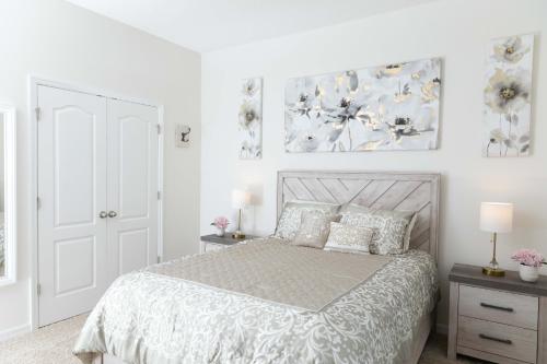 a bedroom with a bed and two paintings on the wall at Marvelous Villa, South facing pool and hot tub, themed bedrooms near Disney in Davenport