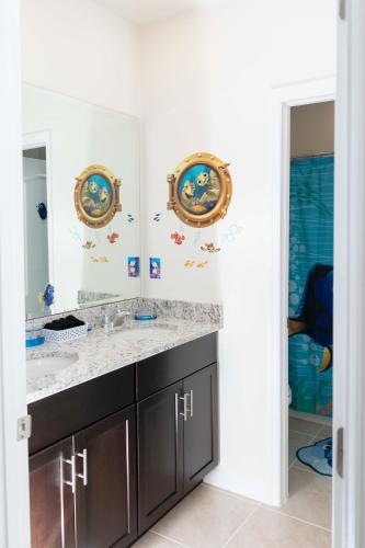 a bathroom with a sink and a mirror at Marvelous Villa, South facing pool and hot tub, themed bedrooms near Disney in Davenport