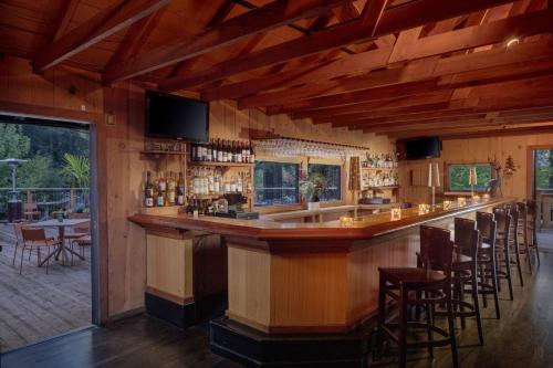 a bar in a restaurant with chairs and tables at Dawn Ranch in Guerneville