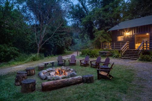 a fire pit in the yard next to a cabin at Dawn Ranch in Guerneville