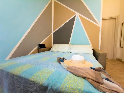 a person laying on a bed with a hat on it at Villa Latino in Vieste