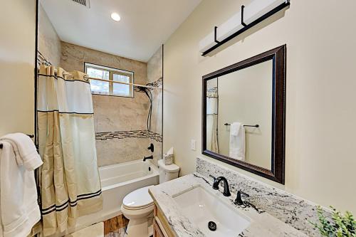 une salle de bain avec un lavabo, des toilettes et un miroir dans l'établissement Saponi Escape, à South Lake Tahoe