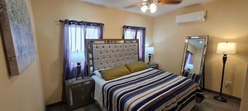 a bedroom with a bed and a large mirror at super condo with fiber optic internet in Puerto Peñasco