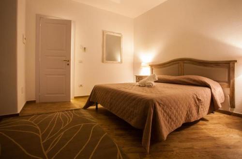 a bedroom with a bed and a dresser at City Garden Guest House in Olbia