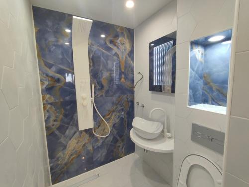 a bathroom with a sink and a toilet in it at Sunset Smart Home in Varna City