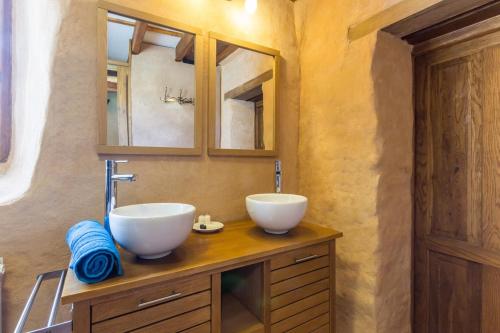 un bagno con 2 lavandini bianchi su un bancone in legno di Chaleureux gîte aux portes de l'histoire a Agy
