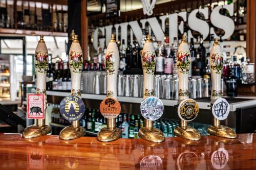 a bar with a bunch of bottles of beer at Rutland Arms Inn in Whanganui