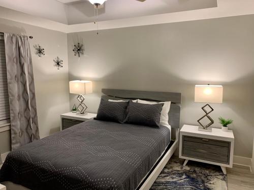 a bedroom with a bed with two night stands and two lamps at Sunset Cove at Calypso III in Panama City Beach